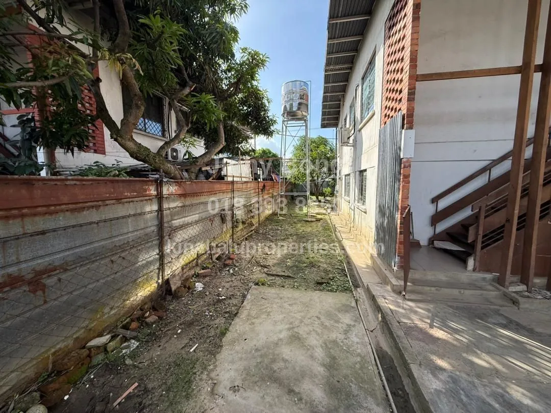 Outdoor space beside the house with elevated water tank